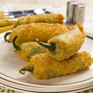 Juicy jalapeno poppers breaded and filled with cheese and fried to golden perfection